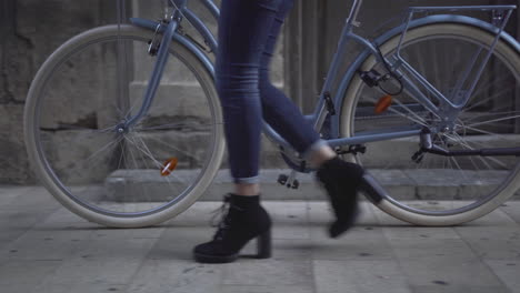 woman walking with a vintage bicycle
