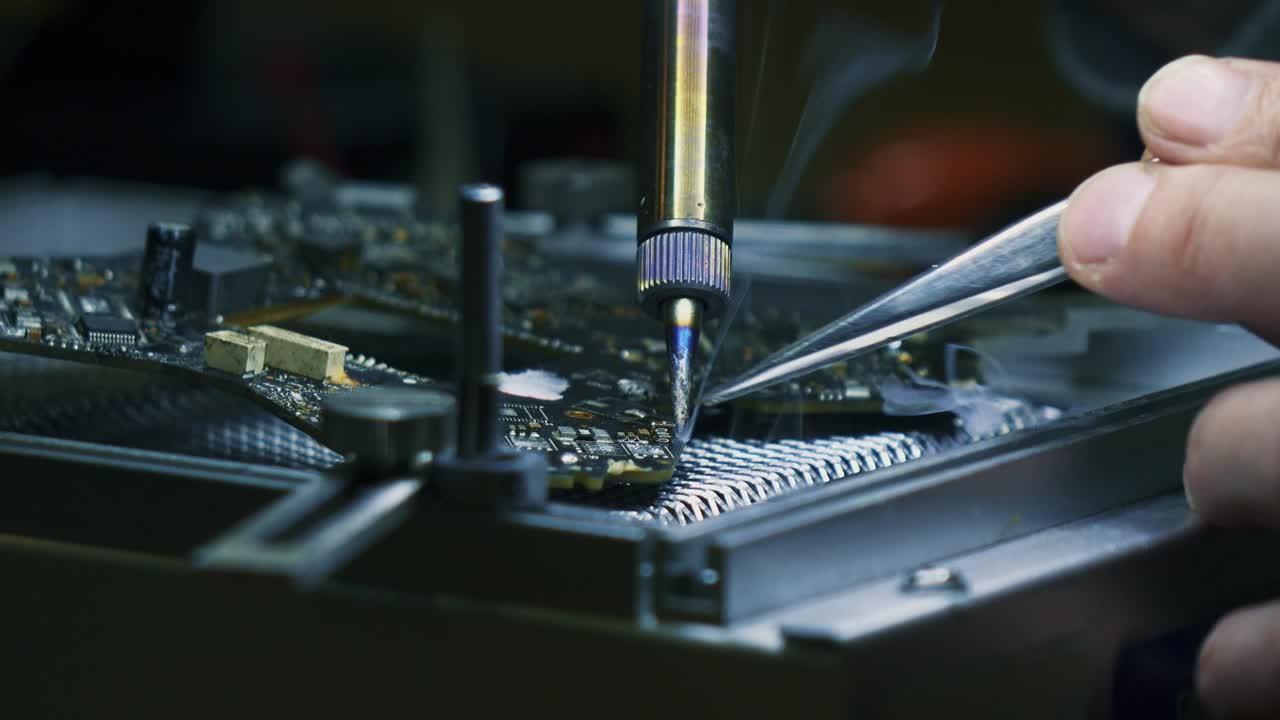 Man fixing a crashed drone. Quadrocopter service laboratory. Tracking shot. 4K