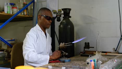 worker using welding torch in glass factory 4k