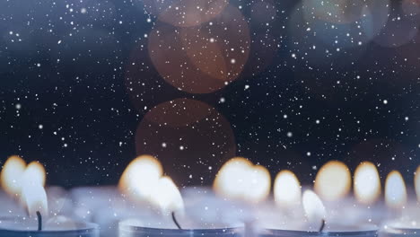 velas combinadas con la nieve que cae