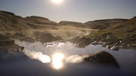 a tranquil wide shot captures the natural beauty of hrunalaug hot spring in iceland during what appears to be golden hour