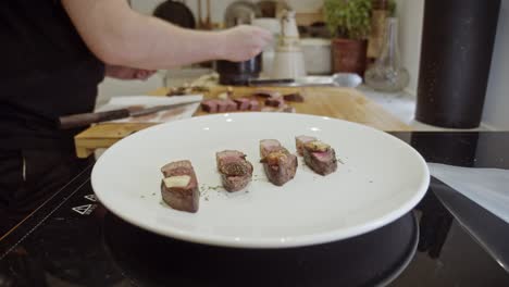 Decorating-steak-dish-on-a-white-plate-with-spices-and-organic-sauce