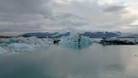 jokulsarlon glacier lagoon, iceland. aerial forward ascending