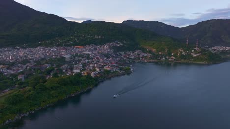 Wide-view-of-San-Pedro-at-Lake-Atitlan-during-sunrise-Guatemala,-aerial