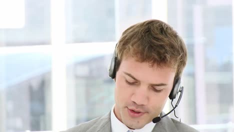 smiling businessman using a headset