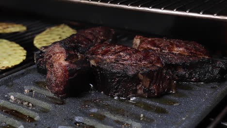 thick juicy filet mignon steaks sizzling on outdoor barbeque grill in backyard, close up shallow depth of field