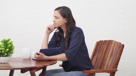 Indian-girl-at-a-cafe-reading-book