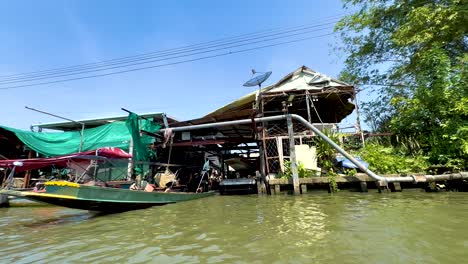 boat travels along canal near floating market