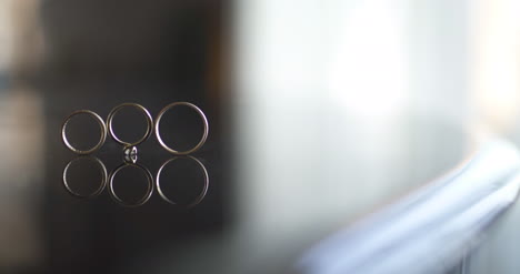 Close-Up-Of-Wedding-Rings-On-Table-3