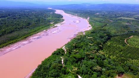 excavator caterpillar d320 in the middle of the yapacani river in santa cruz