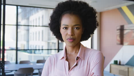 portrait of serious businesswoman standing in empty office