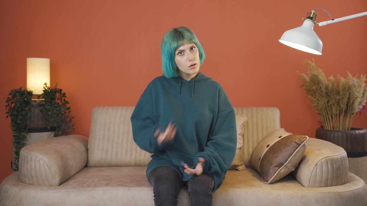 Young woman looking at camera confused.