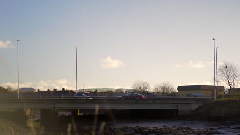 cars traveling over a city bridge day time blue sky