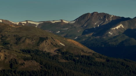 Aerial-cinematic-drone-sunrise-sunlight-early-morning-shadows-Grays-and-Torreys-14er-Peaks-Rocky-Mountains-Colorado-stunning-landscape-view-mid-summer-snow-on-top-zoom-to-the-right-movement