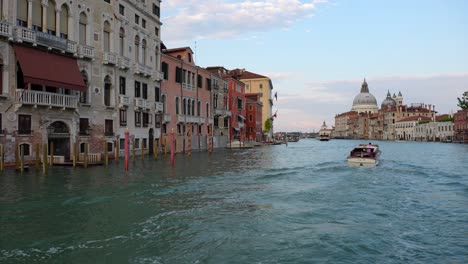 follow shot of a vaporetto taxi navigating the grand canal in venice