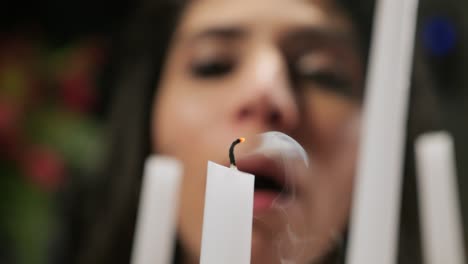 woman blows out a candle