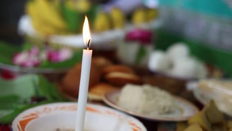 lighting prayer candle offering, sacrificial or memorial candle