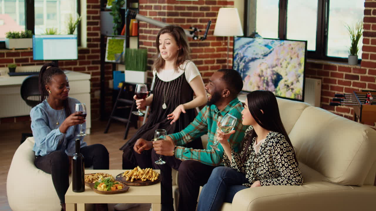 Host chatting with happy multiracial friends in brick wall living room