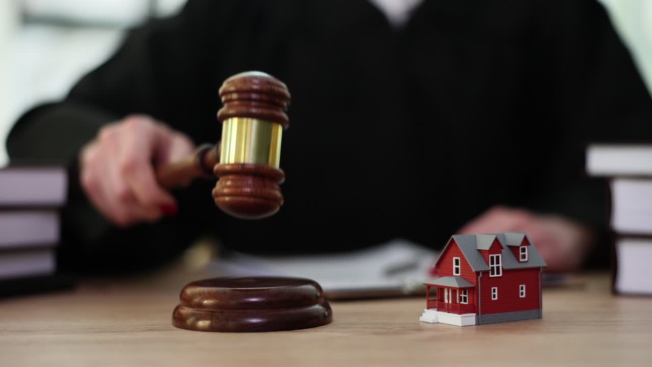 Judge's Gavel and House Model Symbolizing Real Estate Law and Property Disputes