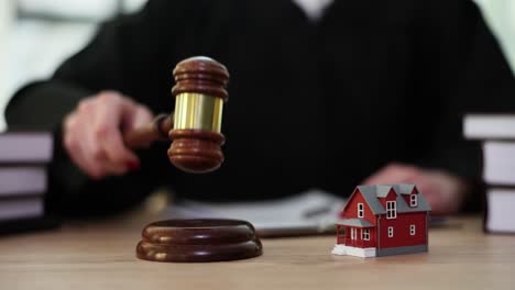 judge's gavel and house model symbolizing real estate law and property disputes
