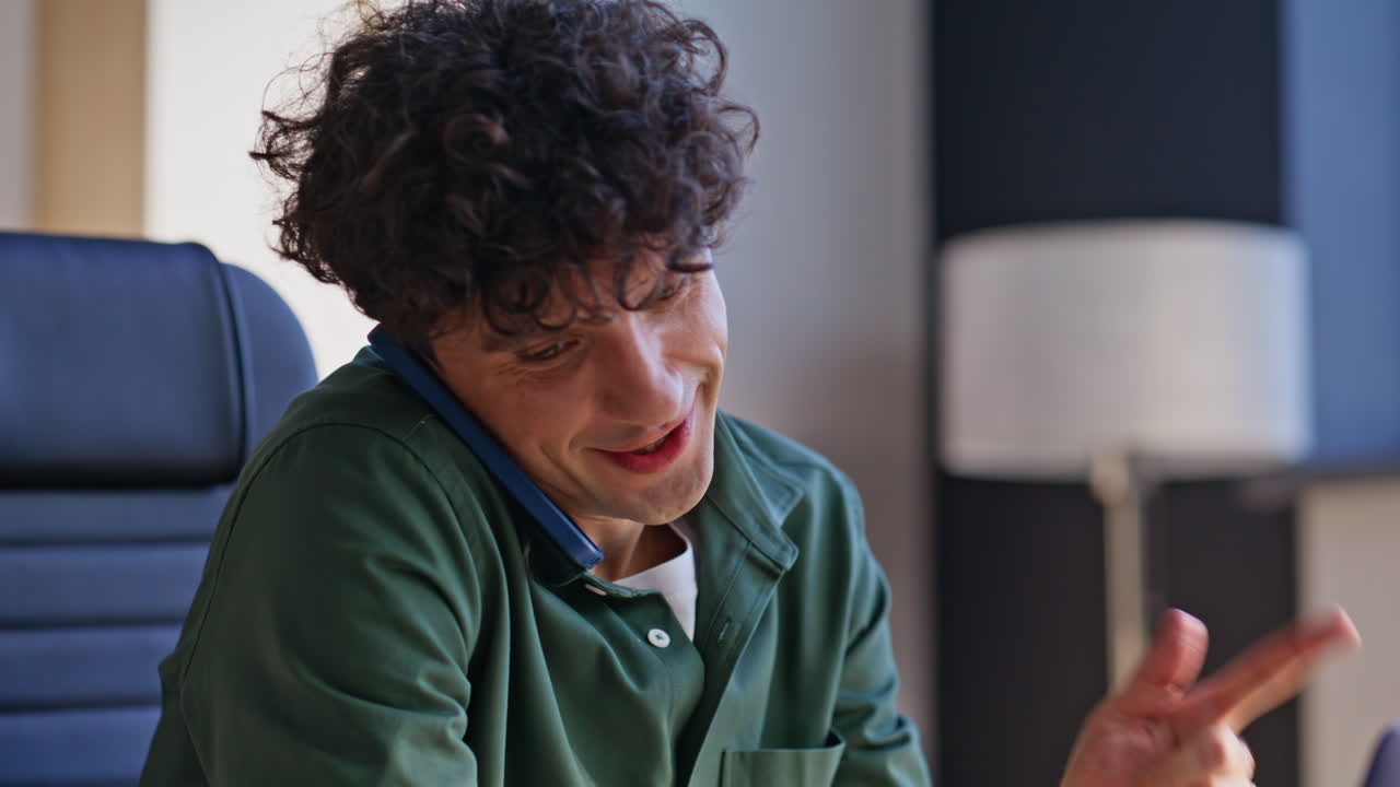 Company worker speaking mobile phone at work closeup. Smiling manager typing