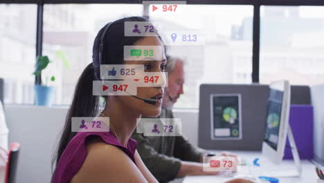 animation of icons and numbers over biracial businesswoman in office