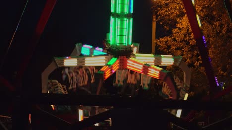 attraction swing in the amusement park evening lights