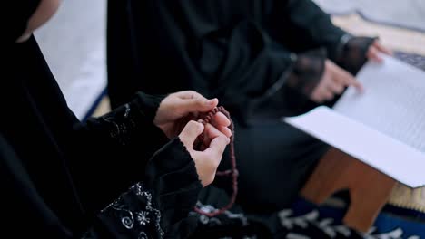 close up hand of young muslim woman while read quran