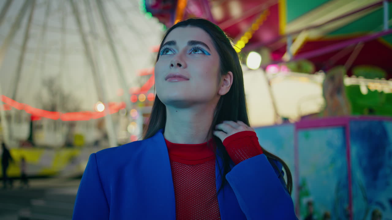 Happy girl rest luna theme park at night closeup. Smiling trendy model posing