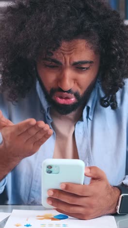 man deeply focused on his phone in a casual setting exploring new connections