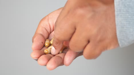 a hand holding a handful of pills