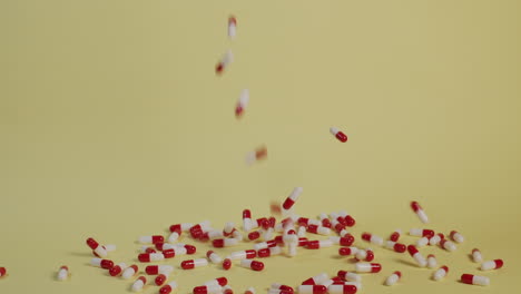 Slow-motion-wide-shot-of-a-handful-of-pills-as-they-fall-vertically-and-bounce-around