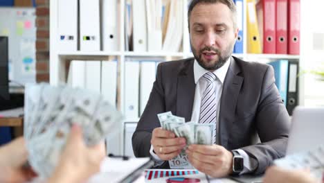 business people count cash american banknotes in office