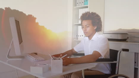 animation of landscape over disabled african american man sitting in wheelchair