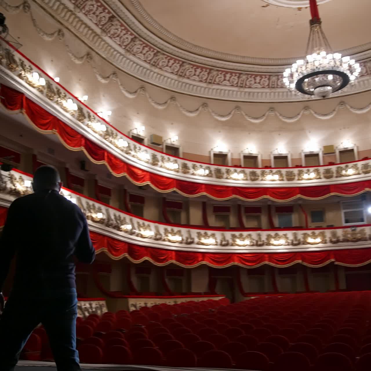 Successful Motivational Speaker. Empty classic theater. No people in hall because of pandemic