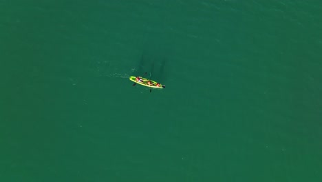 Top-down-shot-of-a-family-kayaking-in-the-tropical-waters-of-Mendoza,-Argentina