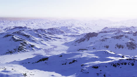 snow covered mountain landscape under bright sunlight in winter