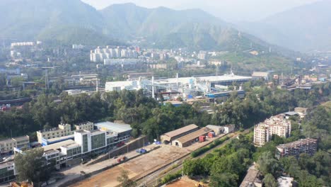 drone shot of an industrial city located in the valley of sichuan, china