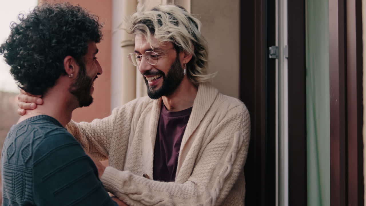Gay Couple Sharing a Laugh on Balcony
