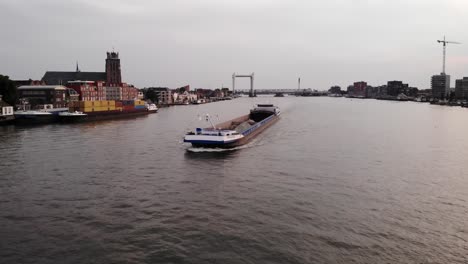 High-angle-shot-over-Insomnia-cargo-ship-carrying-silt-in-Netherlands-at-sunset