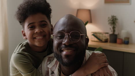 Father-and-son-hugging-at-home