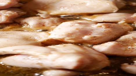 close-up of chicken pieces being fried in a pan