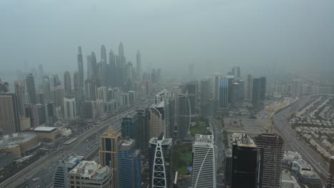 4k: foggy morning at dubai marina district, dubai skyscrapers with city traffic