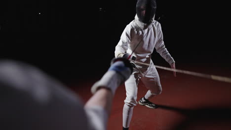 fencer in action during a fencing competition