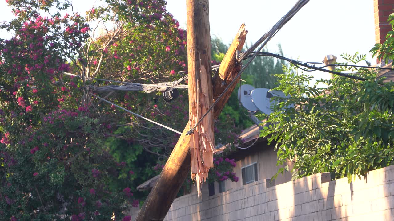 wooden telephone pole snapped in half
