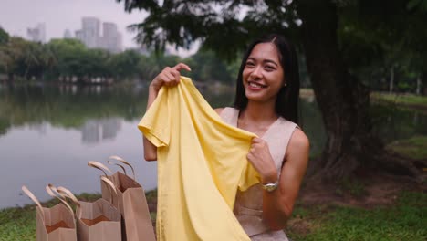 woman happy after shopping in park