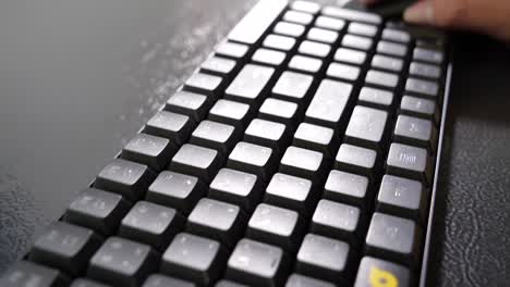 asian hand using black mouse and keyboard, close up