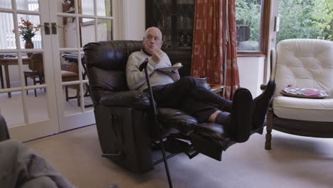 an elderly man relaxing in his living room