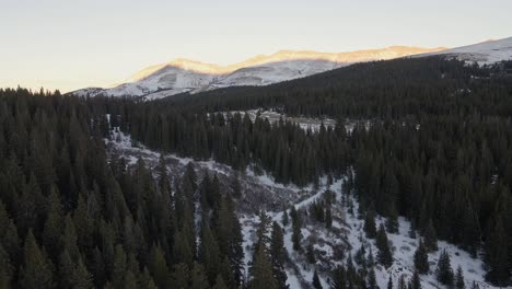 aerial flight along north star mountain towards a mountain pass at sunset, with hoosier ridge in the distance