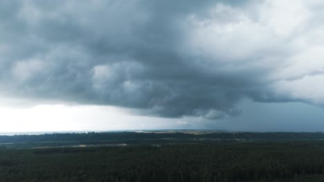 epic dark clouds above countryside landscape of lithuania, aerial view